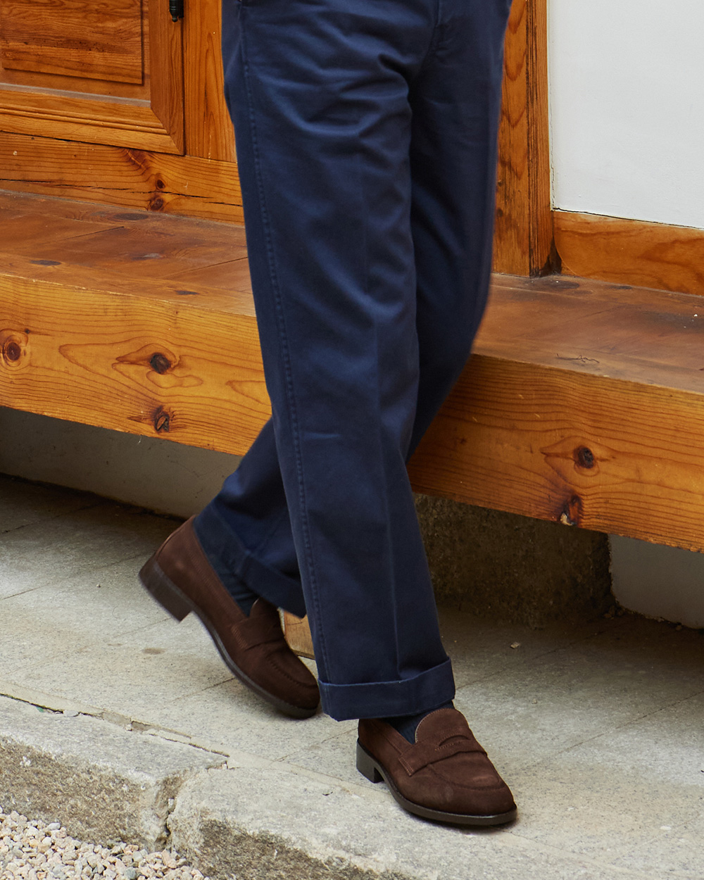 Brown suede penny loafers with navy chinos — classic ivy style footwear