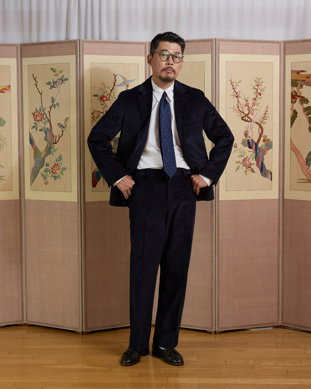 Navy corduroy sack suit with a polka dot tie — the dressier trad end of the ivy spectrum