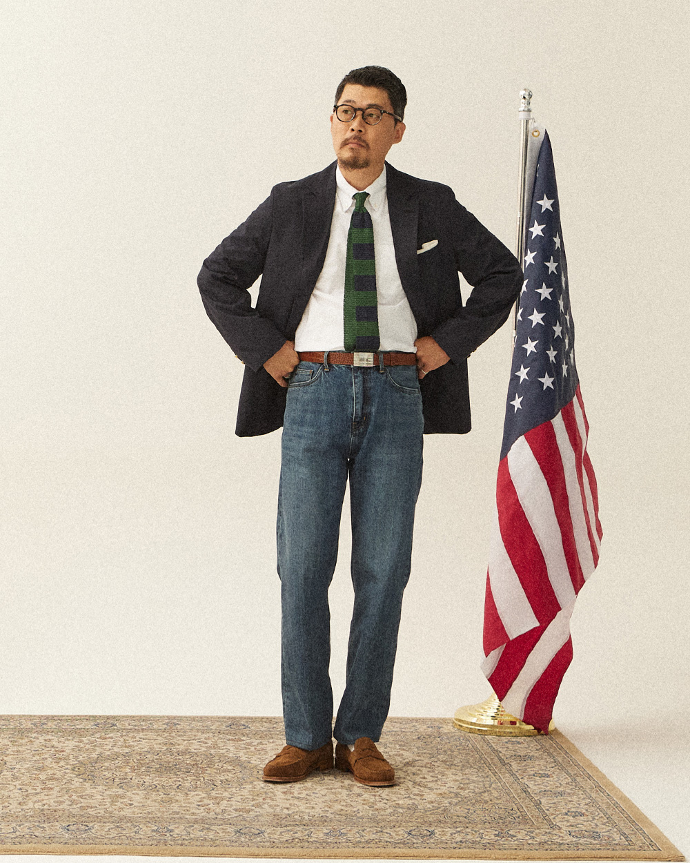 Navy blazer with a green knit tie and mid-wash jeans with suede loafers โ the three rules of casual blazer outfits