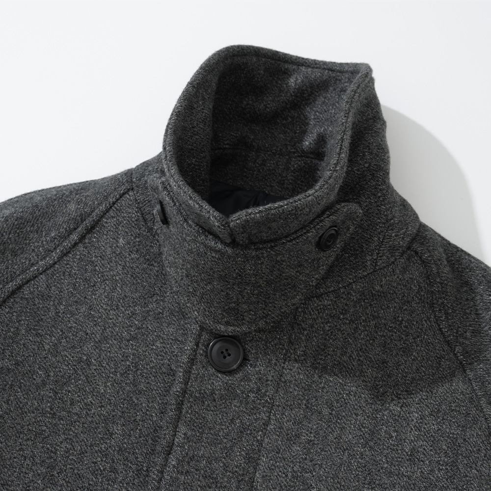Herringbone wool balmacaan with the Prussian collar turned up