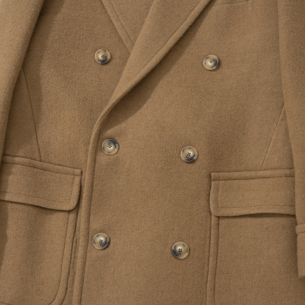 Six-button double-breasted front of a camel polo coat