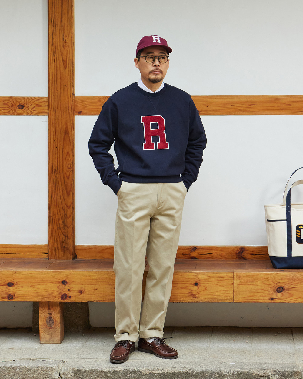 Khaki chinos worn with a navy collegiate sweatshirt and boat shoes in front of a Seoul hanok, the weekend end of the chino range