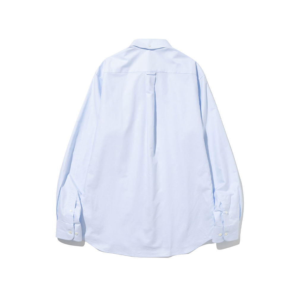 Back of a light blue oxford cloth button-down shirt laid flat, showing the yoke, the back-collar button, the locker loop and the center box pleat