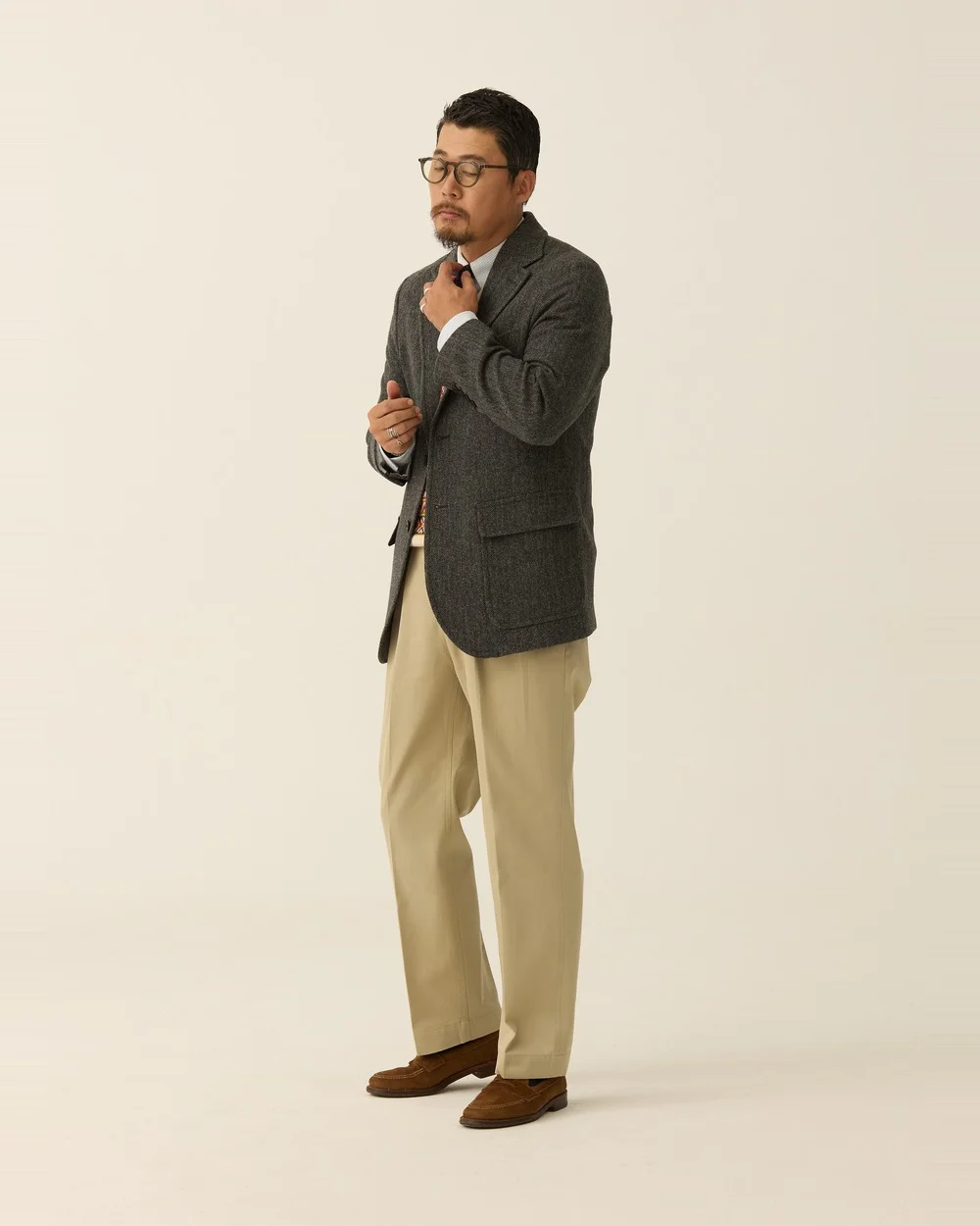 Grey herringbone blazer with white OCBD, knit tie and khaki chinos — the chino version — Renacts FW26 lookbook