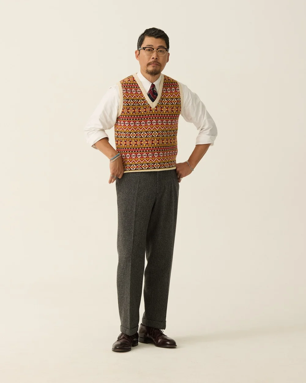 Herringbone Pipe Stem Trouser [Grey] worn on its own with a Fair Isle vest, white OCBD and burgundy penny loafers — Renacts FW26 lookbook (in stock)