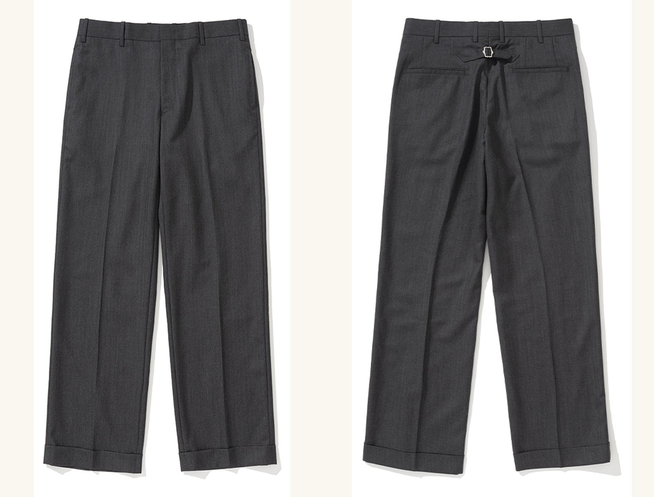 Charcoal herringbone wool trousers laid flat, front and back side by side: a flat front with a centre crease, and a back with a cinch buckle above two welt pockets