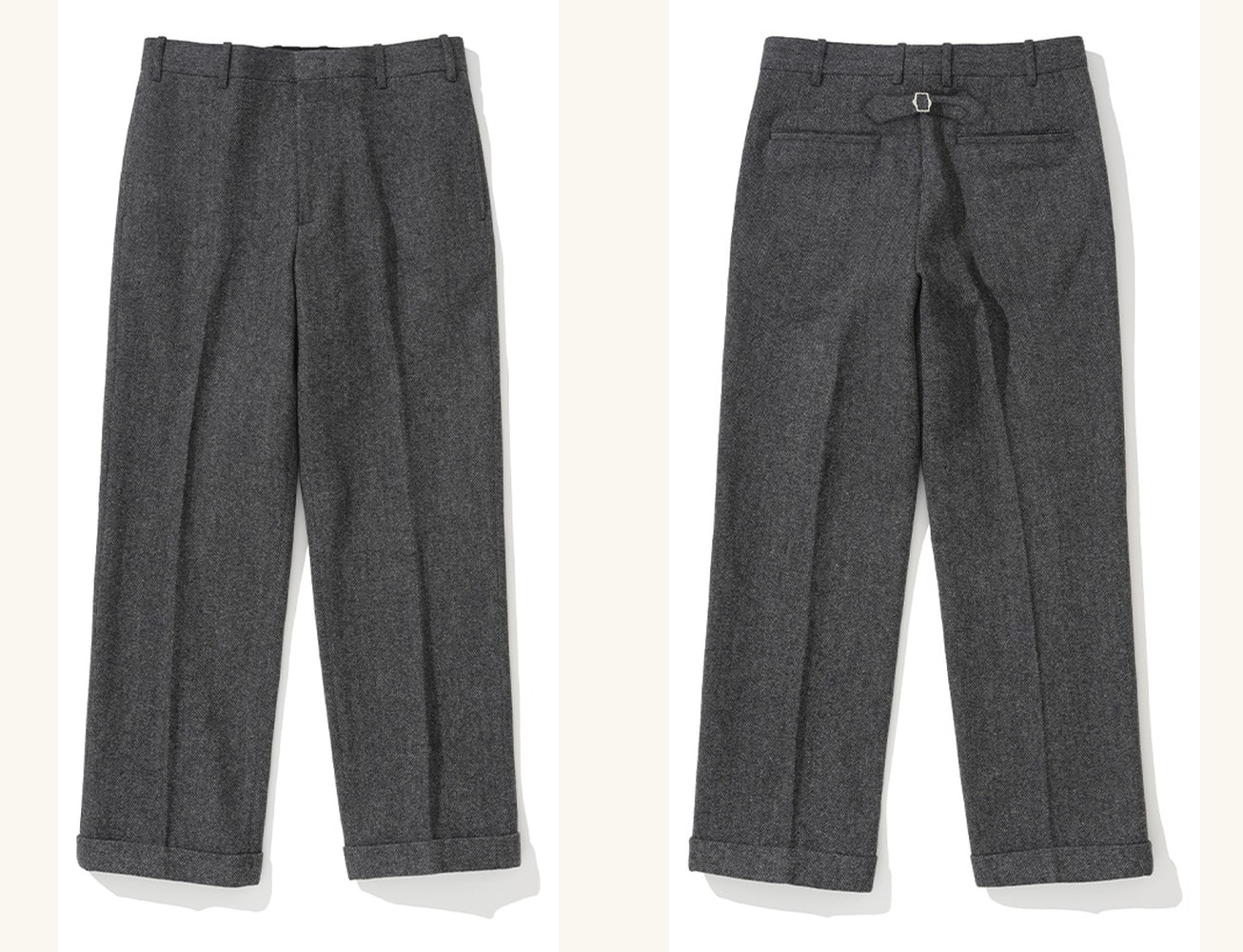 Grey herringbone tweed trousers laid flat, front and back side by side: a flat front with a centre crease and turn-up cuffs, and a back with welt pockets