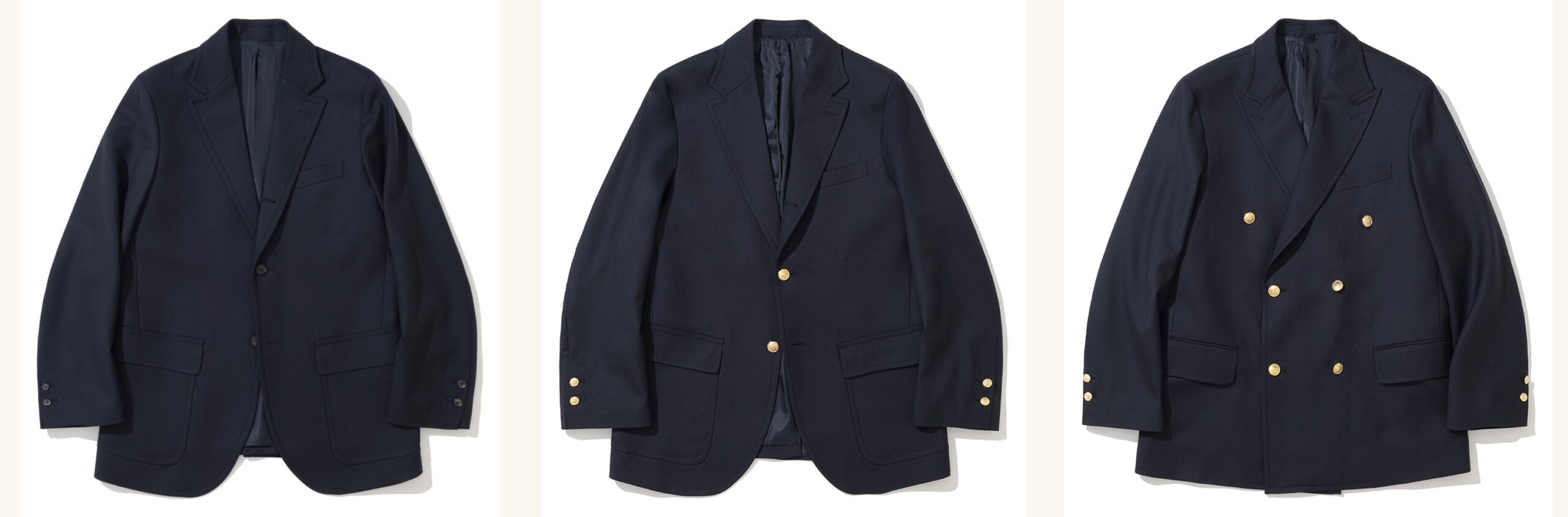 Three navy wool sack-cut blazers laid flat side by side: a single-breasted blazer with dark buttons, a single-breasted blazer with gold buttons, and a double-breasted blazer with six gold buttons and peak lapels