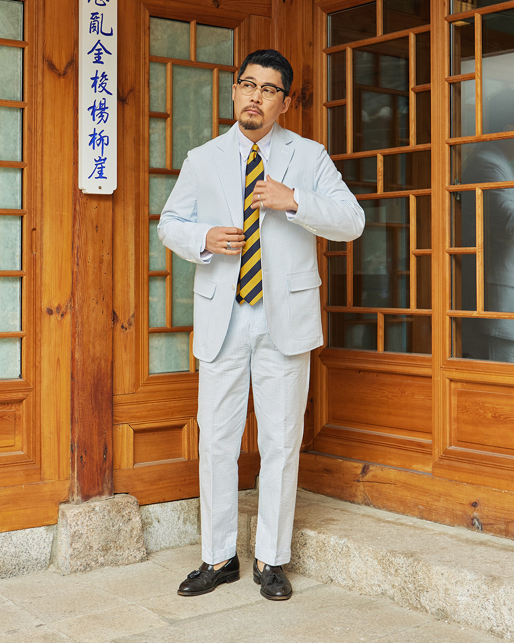 sport coat fabrics: blue and white striped seersucker jacket and matching trousers with a navy and gold repp tie, the lightest summer tailoring fabric