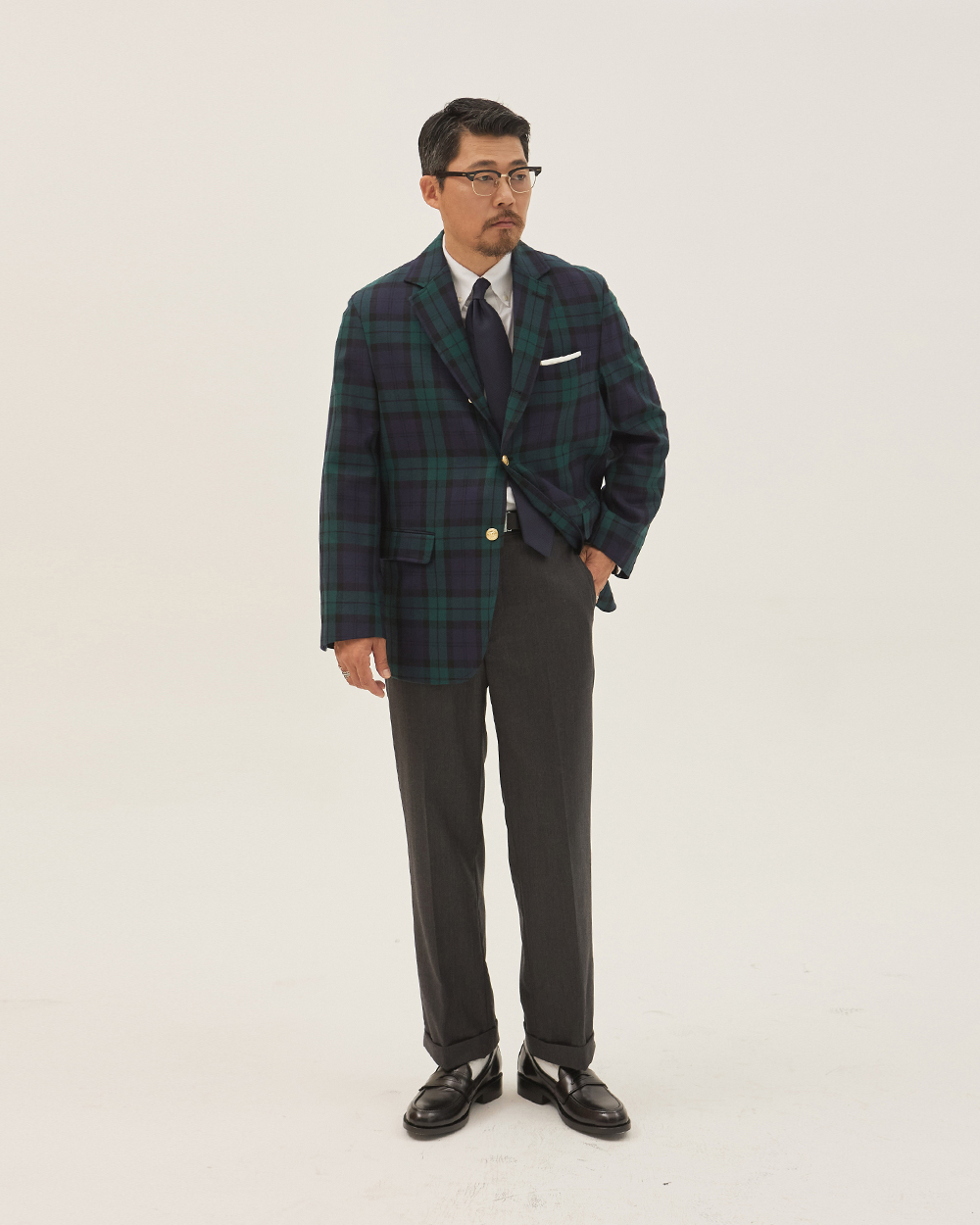 sport coat fabrics: Black Watch tartan wool sack cut blazer with gilt buttons, grey flannel trousers and black penny loafers, the loudest Trad sport coat pattern