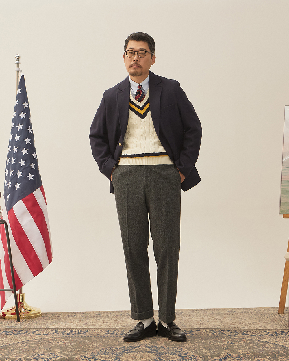 sport coat fabrics: navy Abraham Moon tweed sack cut blazer worn with a cream cricket V-neck sweater, repp stripe tie and grey flannel trousers