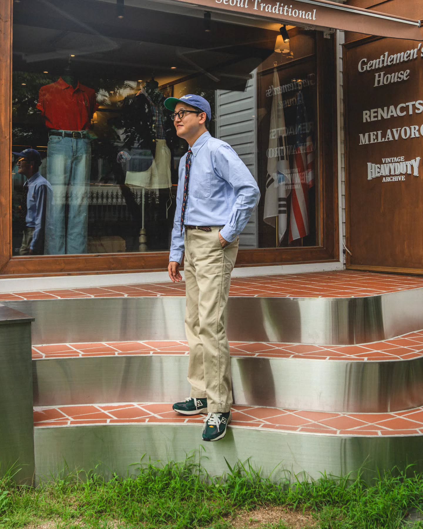 Side view of khaki chino hems meeting the uppers of green sneakers.