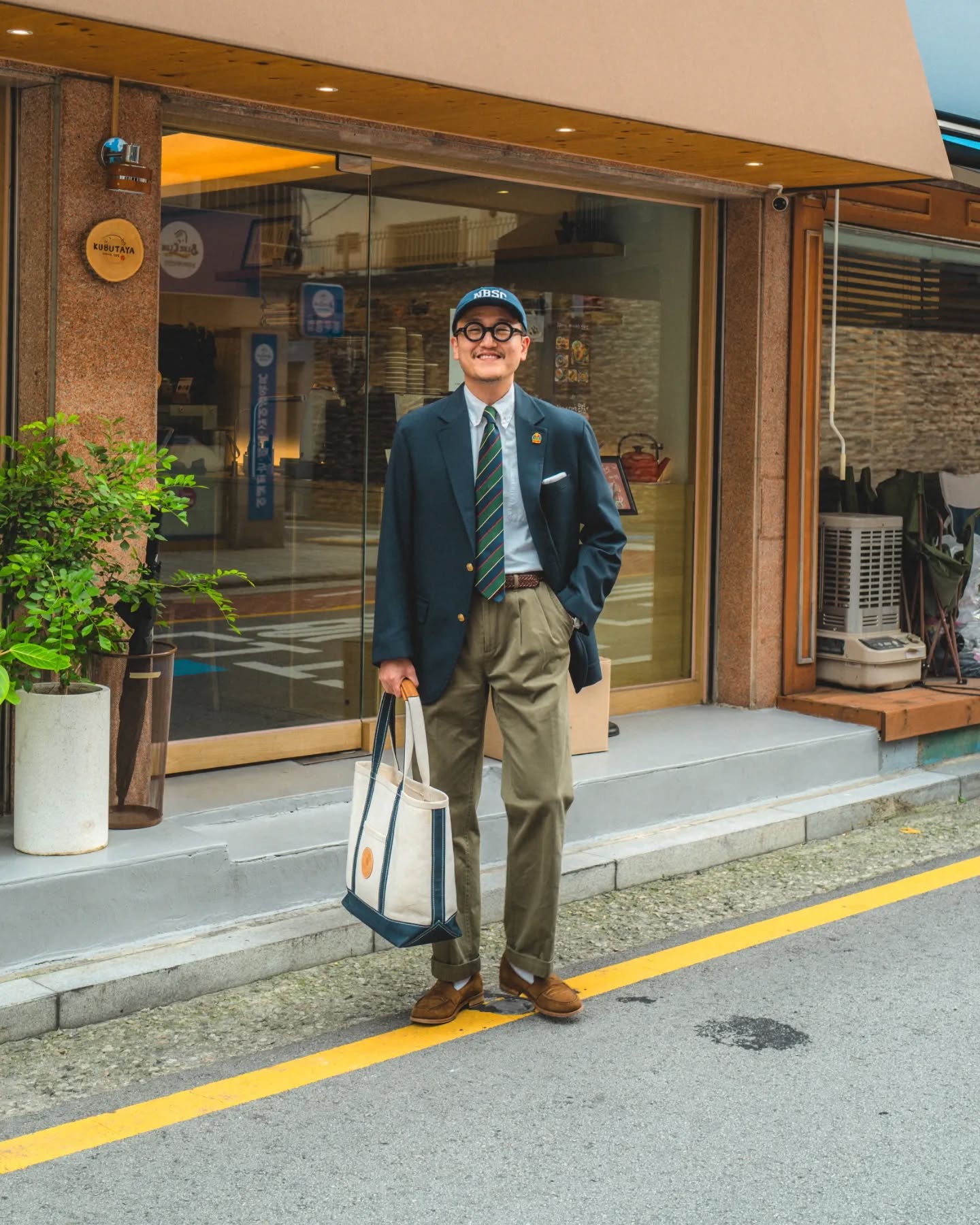 Gold-button blazer and striped tie with olive chinos and brown loafers.