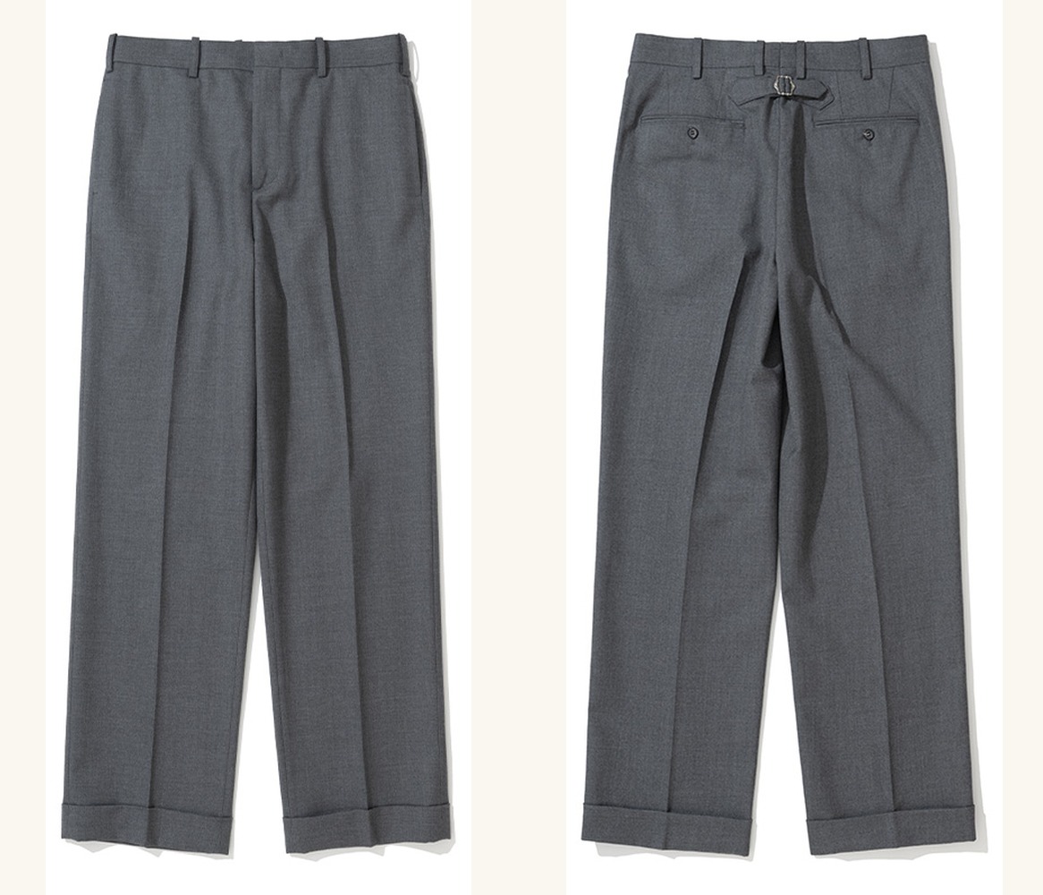 Grey wool trousers laid flat, front and back side by side: a flat front with no pleats and turn-up cuffs, and a back with a cinch-back buckle between two welt pockets