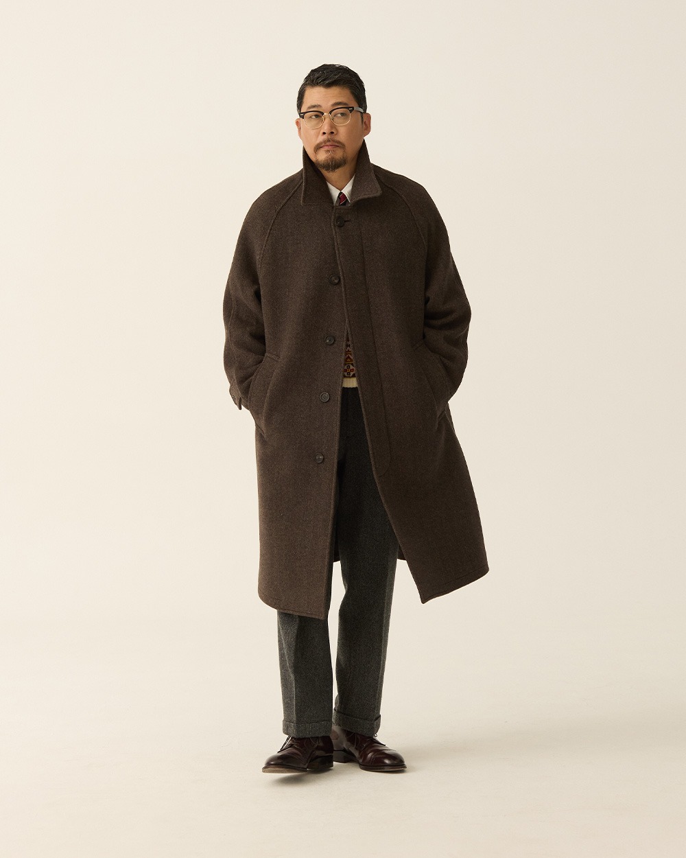 A separate brown-coat outfit, buttoned over grey trousers, for comparison with the open Fair Isle look.