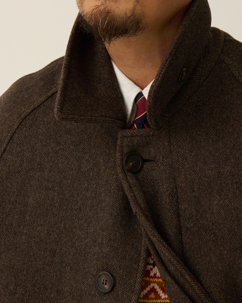 Original close-up of the brown herringbone cloth, collar and front fastening.