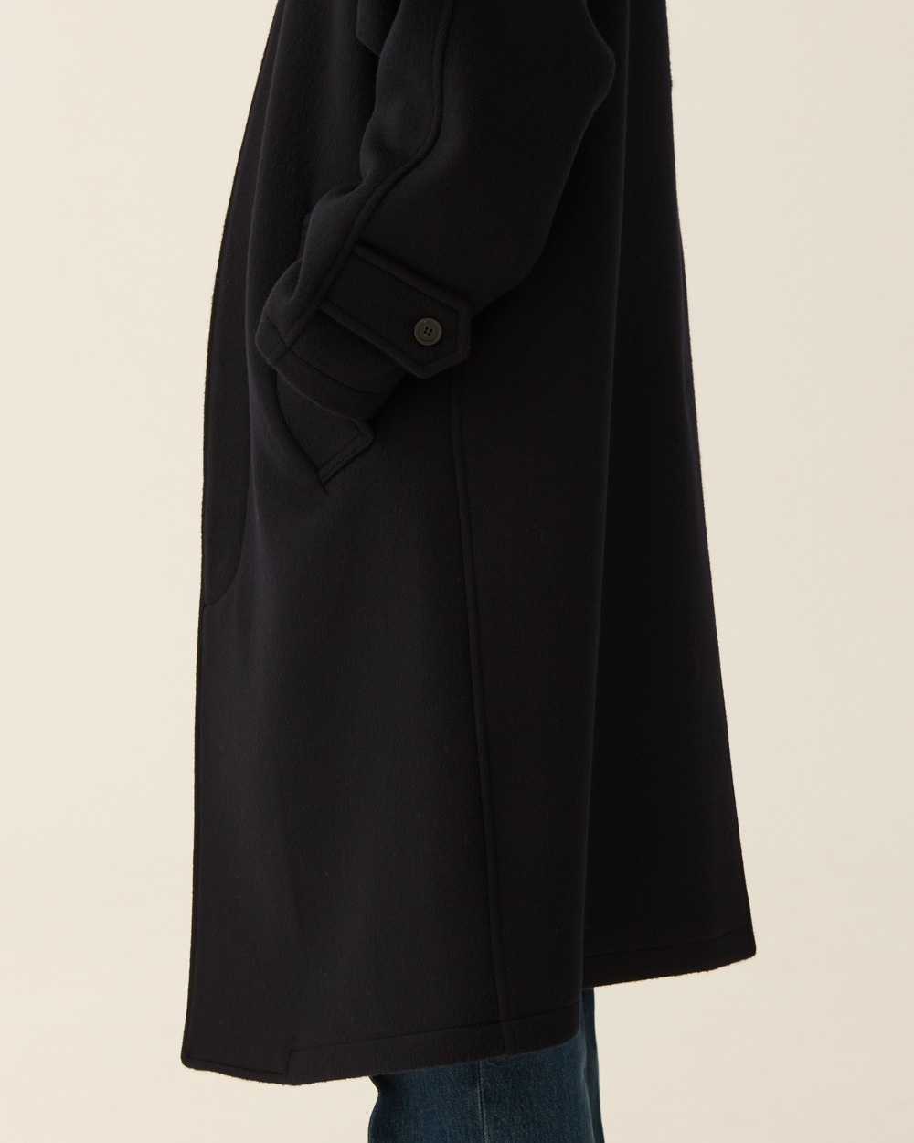 Original detail photograph of the navy coat cuff tab and side pocket.