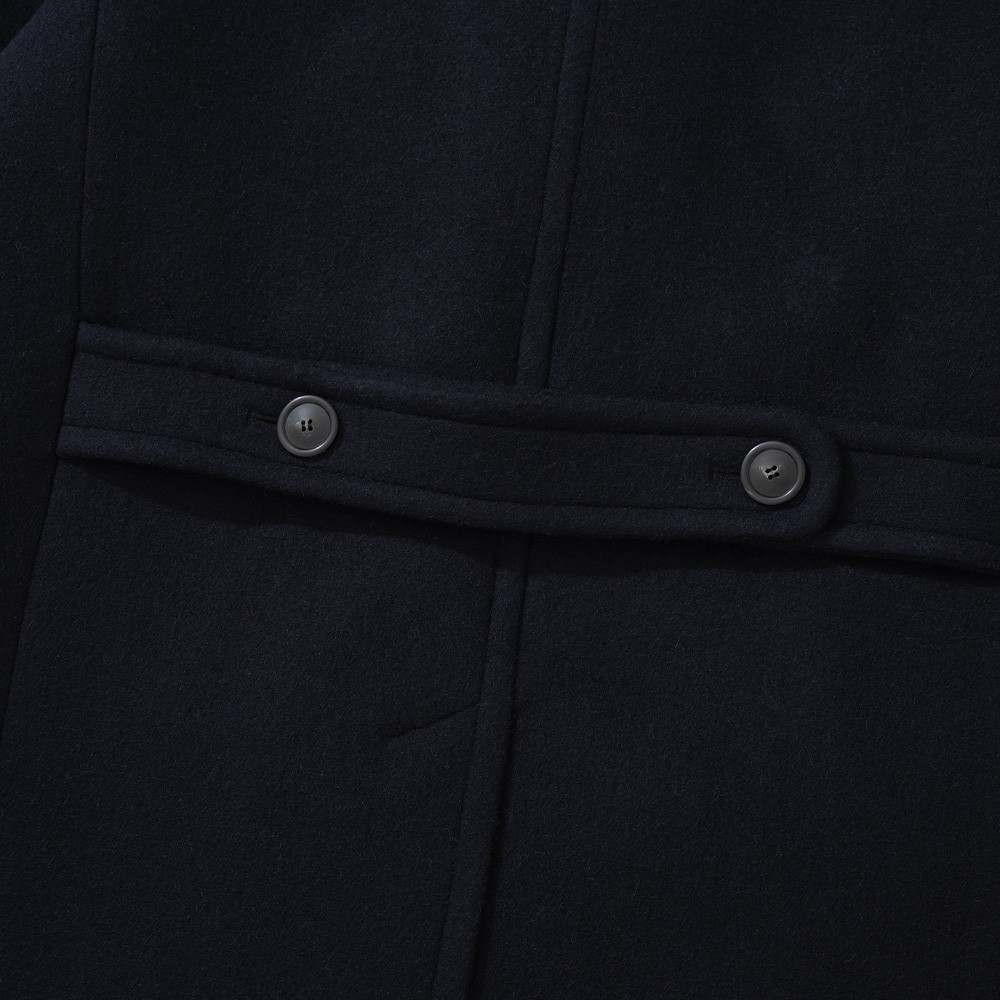 Half belt with two buttons across the back of a navy polo coat